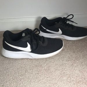 Women’s black Nike Tanjun sneakers
